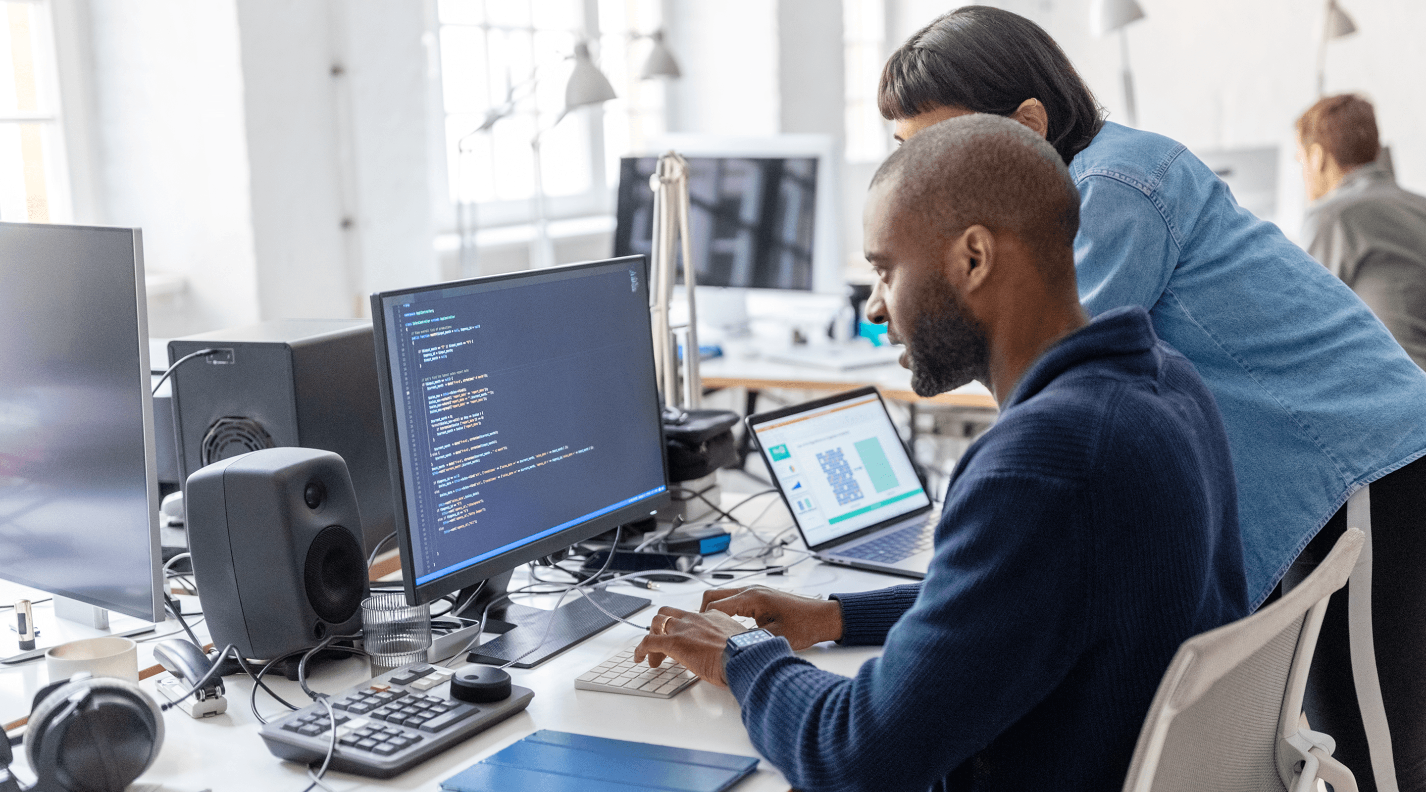 Um homem e uma mulher olhando para uma tela de computador